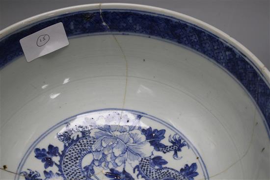 A large Chinese blue and white bowl, 29.5cm a prunus jar, height 12cm and a Kangxi blue and white fluted saucer, 11cm